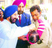 Civil Surgeon Dr S.S. Walia administers polio drops to a child at the Civil Hospital in Jalandhar on Sunday