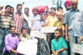 Activists of the Jammu West Assembly Movement protest against rising prices in Jammu on Sunday.