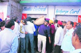 Farmers outside the seed distribution centre in Kullian village in Jammu on Sunday.