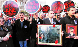 Relatives and friends of a car bomb victim hold portrait and placards that read "We condemn terrorism" in Istanbul on Sunday. 