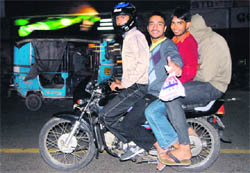 Students violate traffic laws on the main road near Panjab University in Chandigarh on Monday. 