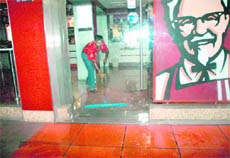 A man wipes blood from the floor at the KFC in Sector 35, Chandigarh, on Monday evening.