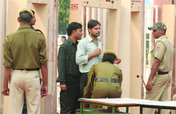 Delhi police personnel frisk visitors during IITF-2009 at Pragati Maidan in New Delhi 