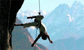 Members of Project Bandaloop perform a dance in the backdrop of the Nanda Devi peak in Chamoli district of Uttarakhand