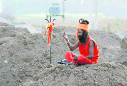 Unmindful of activity around him, this sadhu is engrossed in meditation at a construction site near Madhuban (Karnal). 