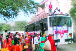 Stranded devotees rush to catch a bus at Purmandal in Samba on Monday.