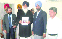 Punjab Chief Minister Parkash Singh Badal releases a brochure on development schemes in Amritsar. A Tribune photo