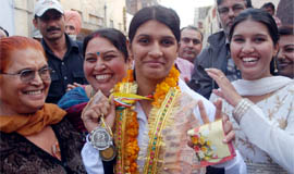 Diksha Gulati, who romped home after winning a silver in boxing at the Junior National Championship held in Patna recently, being welcomed by residents of Parasram Nagar in Bathinda on Tuesday.