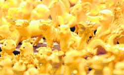 Gold items are displayed in a shop in Hong Kong on Tuesday. Hong Kong gold prices opened at a record high of $1,140.00-1,141.00 an ounce on Tuesday, up from $1,131-1,132 the day before.