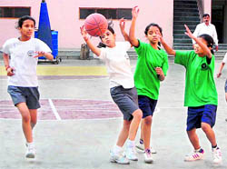 Summer Valley School (white) and Aryan School (green) teams in action at the Inter-Council School Junior Girls Basketball Tournament in Dehradun on Tuesday