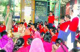 Children pray at the founders day celebrations of their school, Nanhi Duniya, in Dehradun on Tuesday. 