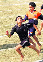 Athletes participate in the 100m at the meet