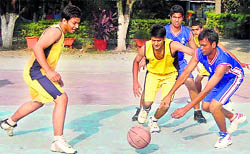 A match in progress between Hilton School (yellow) and Aryan School (blue) at the Senior Boys Council School Basketball Tournament in Dehradun on Tuesday