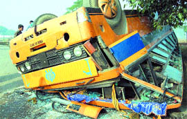 The school bus, which overturned after hitting a DMU, near Bolina station on Tuesday. Tribune photo: Malkiat Singh