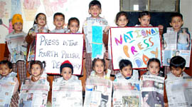 Students of St Soldier Divine Public School hold banners on National Press Day.