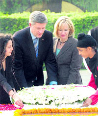 Canadas PM Stephen Harper and his wife Laureen place a wreath at the Mahatma Gandhi memorial at Rajghat, New Delhi, on Tuesday.