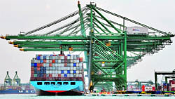 This file photo shows a vessel laden with containers arriving at a port in Singapore. Weak demand from the US and Europe sent Singapore's exports falling for the 18th consecutive month in October, the government said on Wednesday