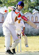 A batsman hits a shot at the Santosh Aggarwal Memorial Institutes Cricket Tournament in Dehradun on Wednesday