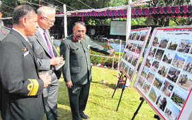 Army officers look at a photo exhibition put up on Corps Day by the Corps of Engineers in Dehradun on Wednesday.