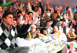 Members of the Jammu Kashmir Agricultural Technocrats Association protest outside the Press Club in Jammu on Wednesday