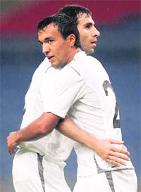 Uzbekistan's Nasimov Bakhodir (R) celebrates with teammate Kapadze Timur after scoring the team's second goal against Malaysia during their AFC Asian Cup 2011 qualifying match in Kuala Lumpur