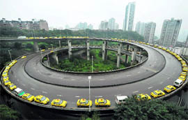 Taxis queue up to get their fuel tanks filled up on an overpass in southwest China's Chongqing municipality on Thursday. Most of central and eastern Chinese provinces are facing the worst liquified natural gas shortages in years as supplies were diverted to snowstorm-hit northern China, while producers lacked incentives to increase output because of the poor profit margins, state media reported