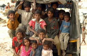 A group of children enjoys a ride on a three-wheeler on the eve of Child Rights Day in Gurgaon