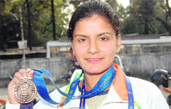 Kiran Tiwari displays the bronze medal that she won at the 18th Asian Athletic Championship.