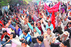 Sugar mill workers hold a demonstration in front of the Uttarakhand Secretariat in Dehradun