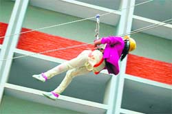 A girl student slides down a rope during an adventure camp organised at St Xaviers School in Sirsa.