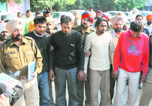 Gang members in police custody in Ludhiana on Thursday.