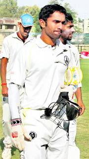 TN skipper Dinesh Karthik coming out of the ground during tea break on Thursday.