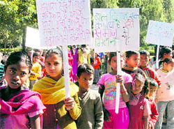 Underprivileged children take out a rally on International Child Rights Day in Dehradun on Friday