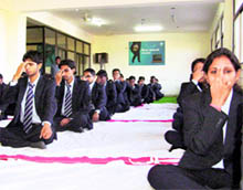 Students attend a yoga camp at Doon Business School in Dehradun on Friday