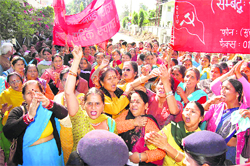 Members of the Anganwadi Sevika Karamchari Union hold a protest outside the state Secretariat in Dehradun
