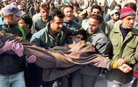 SRTC employees carry a colleague injured in police action in Srinagar on Friday