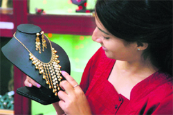 A customer has a close look at a necklace in a shop at Jammus Jain market.