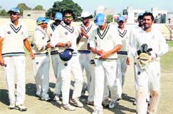 A victorious Tamil Nadu team walks back after dismissing the last Punjab batsman at Amristar on Friday.