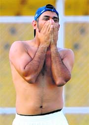 MS Dhoni gestures after the end of first Test at Ahmedabad on Friday.