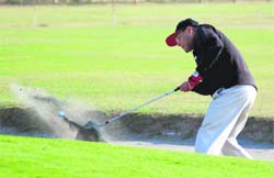 A police official plays a shot at Madhuban Police Academy in Karnal on Friday. 