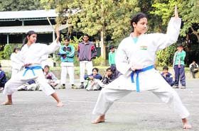 Girls perform exercises at the State Karate Championship in Dehradun