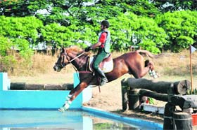A horse rider of the IMA crosses a water hurdle