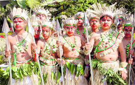 Children dressed as tribesmen pose before their performance in Dehradun on Saturday.