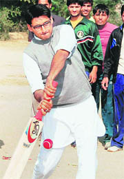 Congress MP Deepender Hooda plays cricket during his visit to a village in Jhajjar on Saturday.
