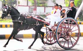 Mokama MLA and JDU leader Anant Singh riding a tonga in protest against the hike in prices of petrol and diesel by the Centre in Patna on Saturday