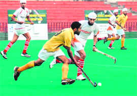 Players in action during a match at the Sector 42 Hockey Stadium in Chandigarh on Sunday.