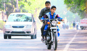 A child learns to ride a mobike on the Panjab University campus in Chandigarh.