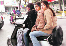 Three riders on a scooter in violation of traffic rules in Mohali on Sunday.