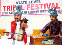 Artistes perform during the Tribal Festival in Jammu on Sunday