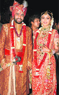Bollywood actress Shilpa Shetty and London-based businessman Raj Kundra pose for the media after their marriage in Khandala on Sunday.